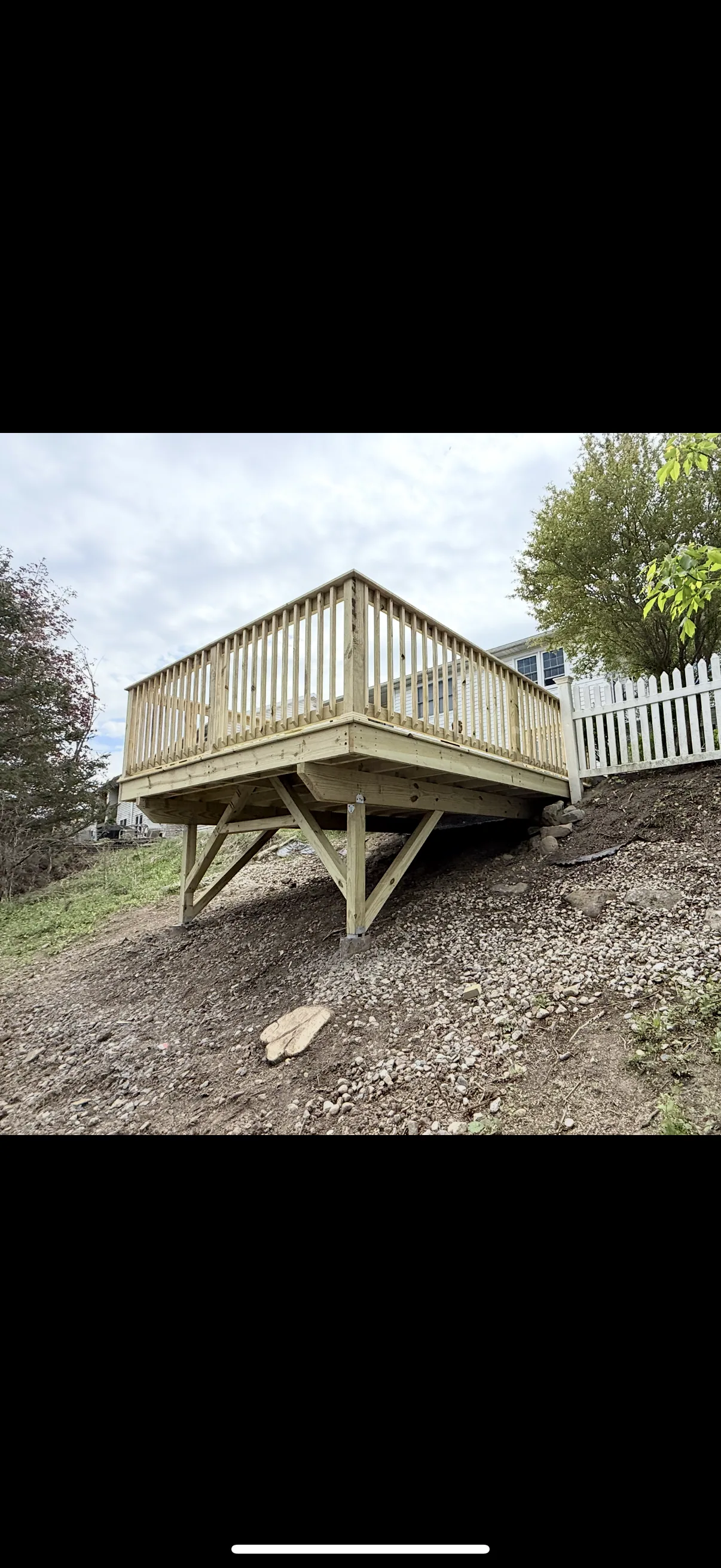 Elevated deck built on posts over a slope