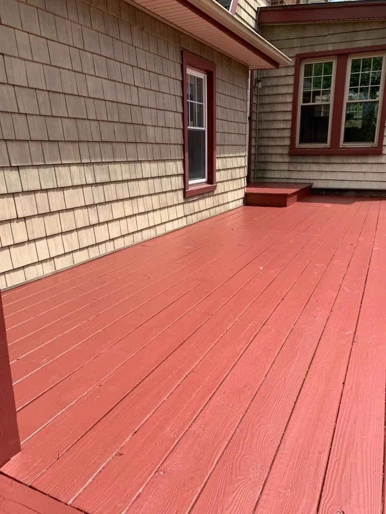 Refinished deck with red stain and railing