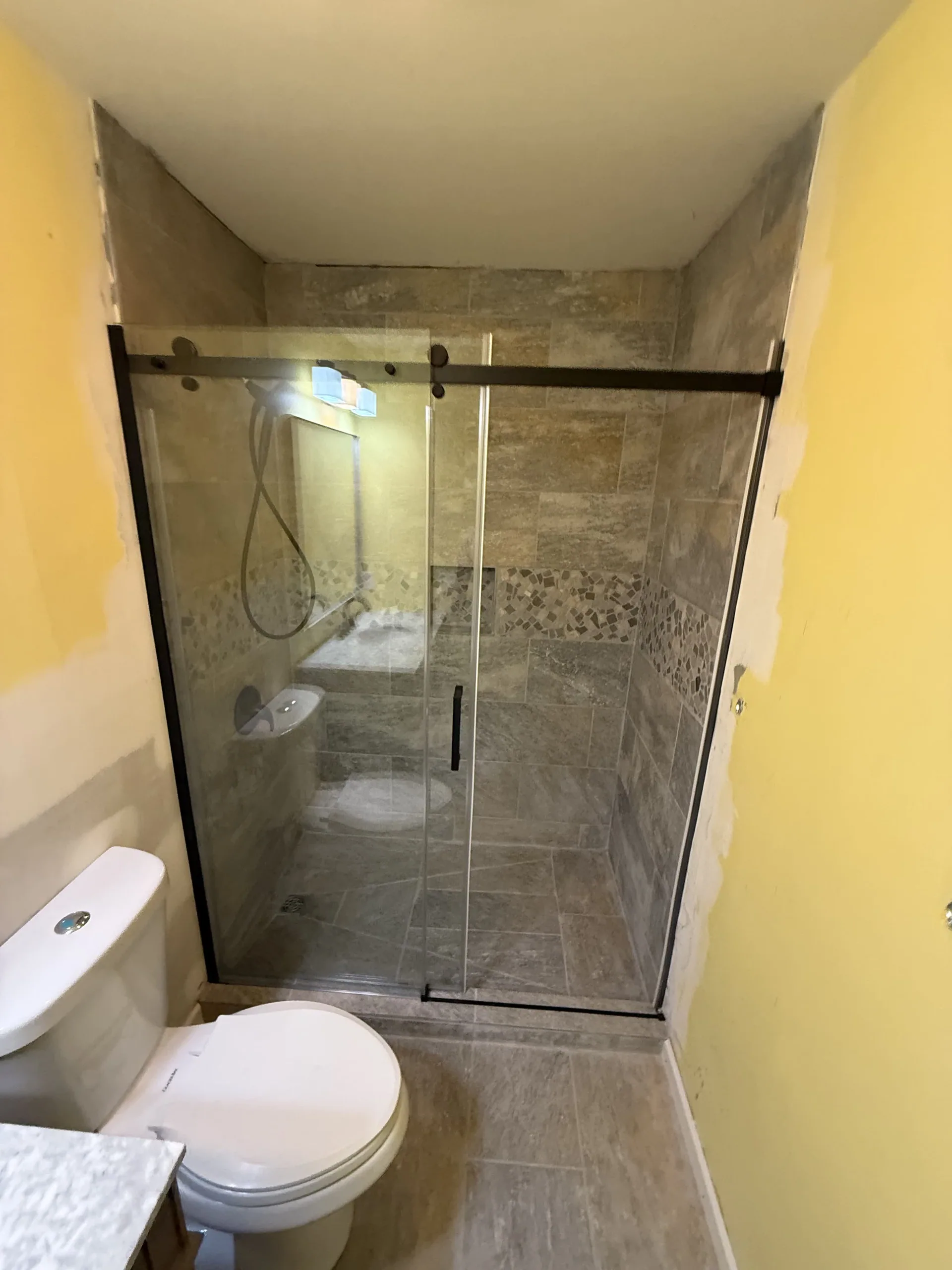 Remodeled bathroom with a frameless glass shower