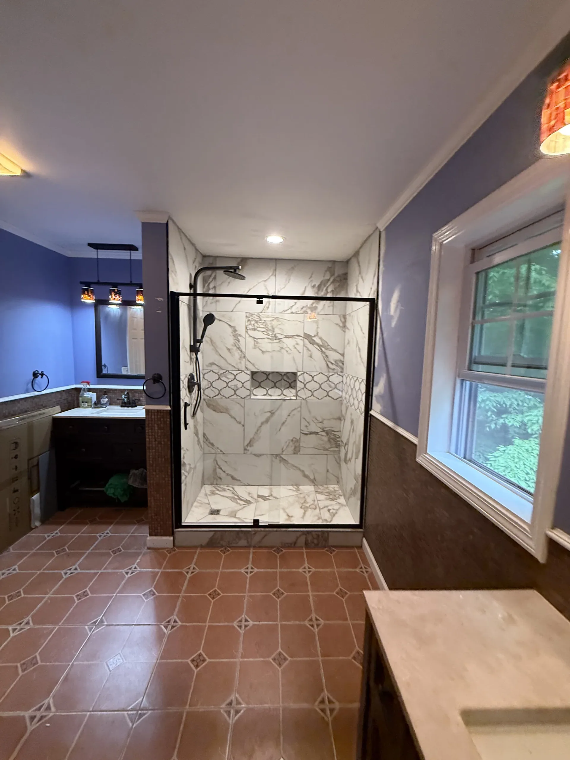 Bathroom remodel with a marble-tiled walk-in shower