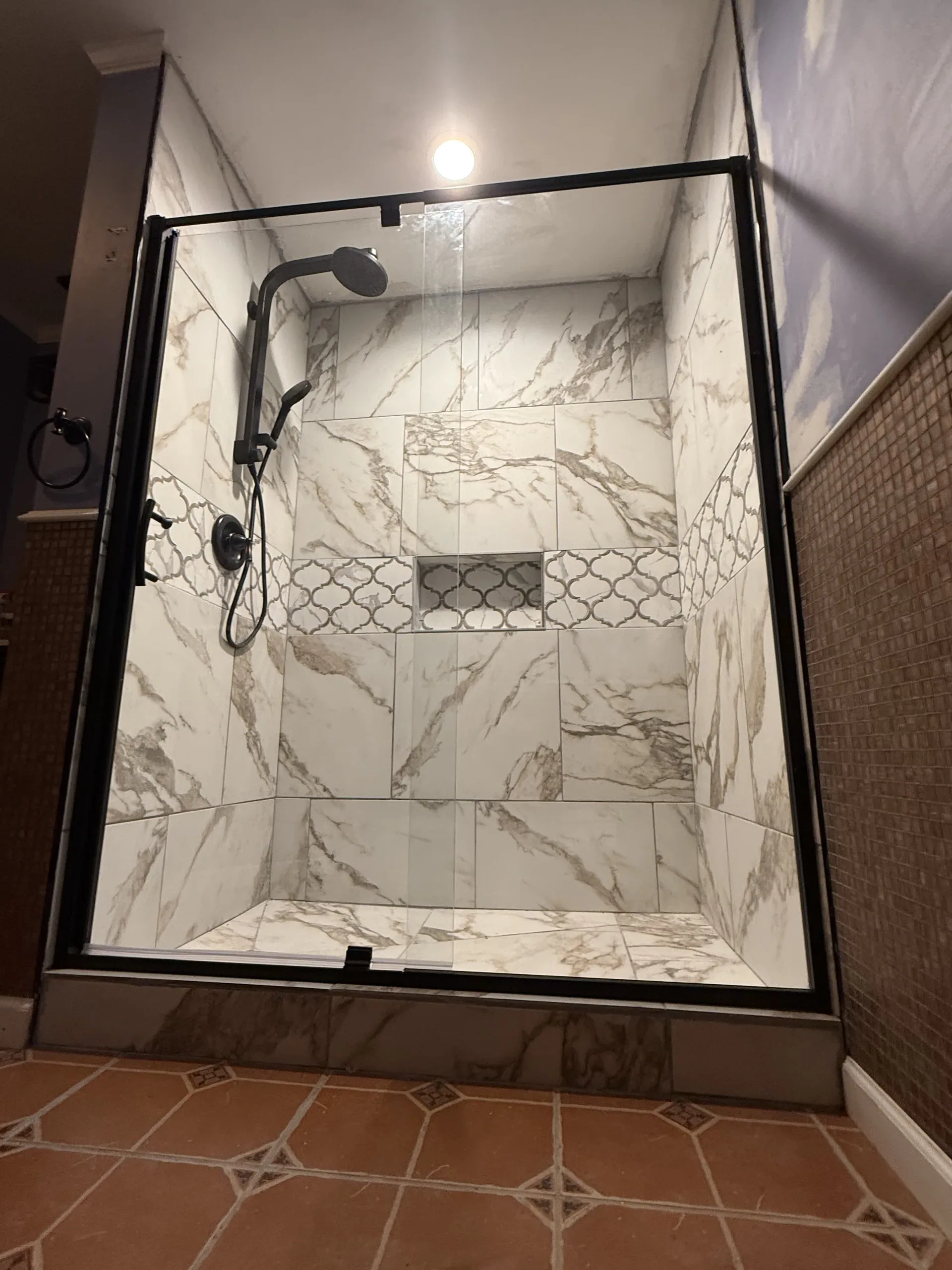Marble walk-in shower detail from a bathroom remodel