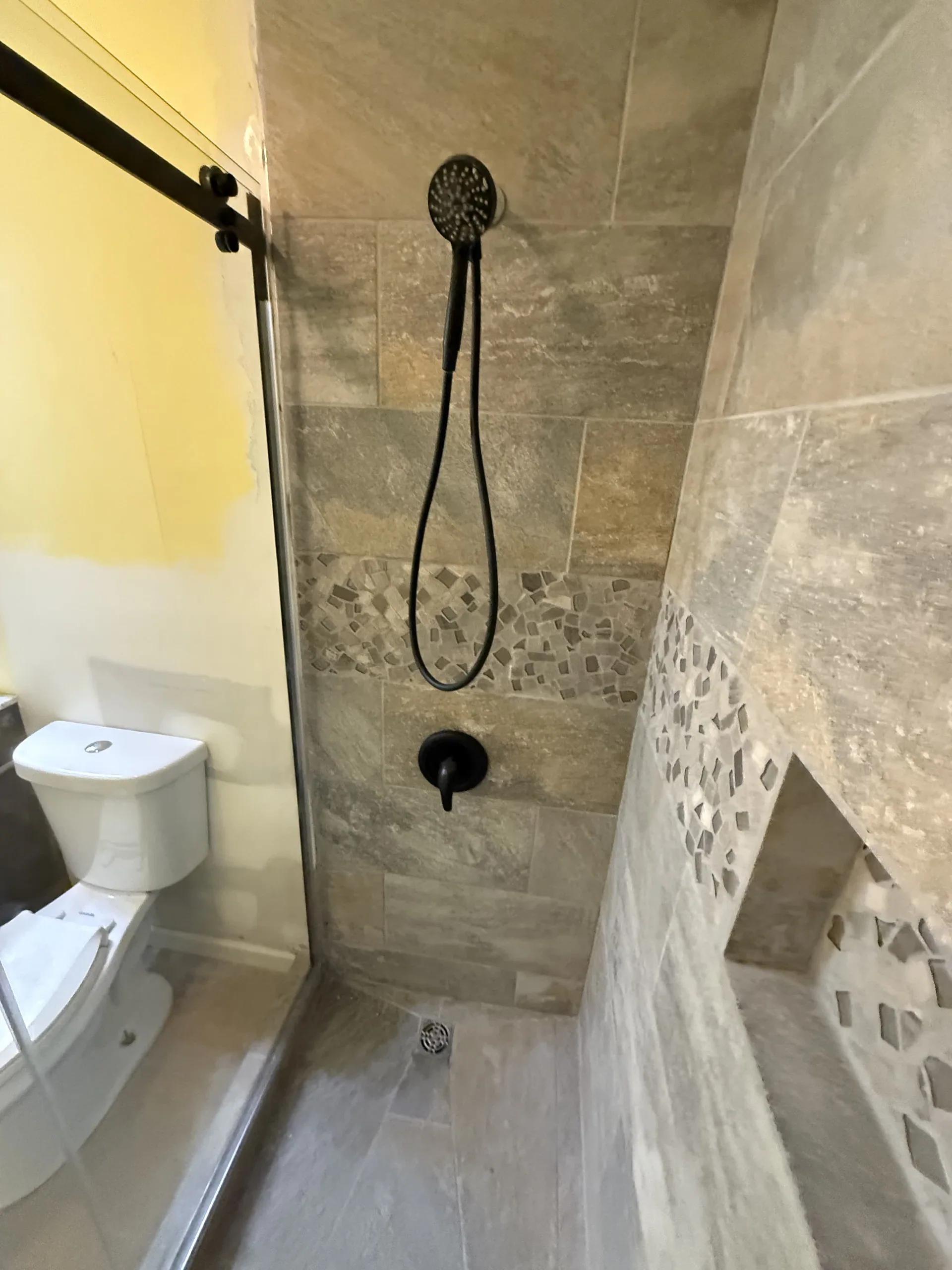 Tiled walk-in shower built during a bathroom remodel