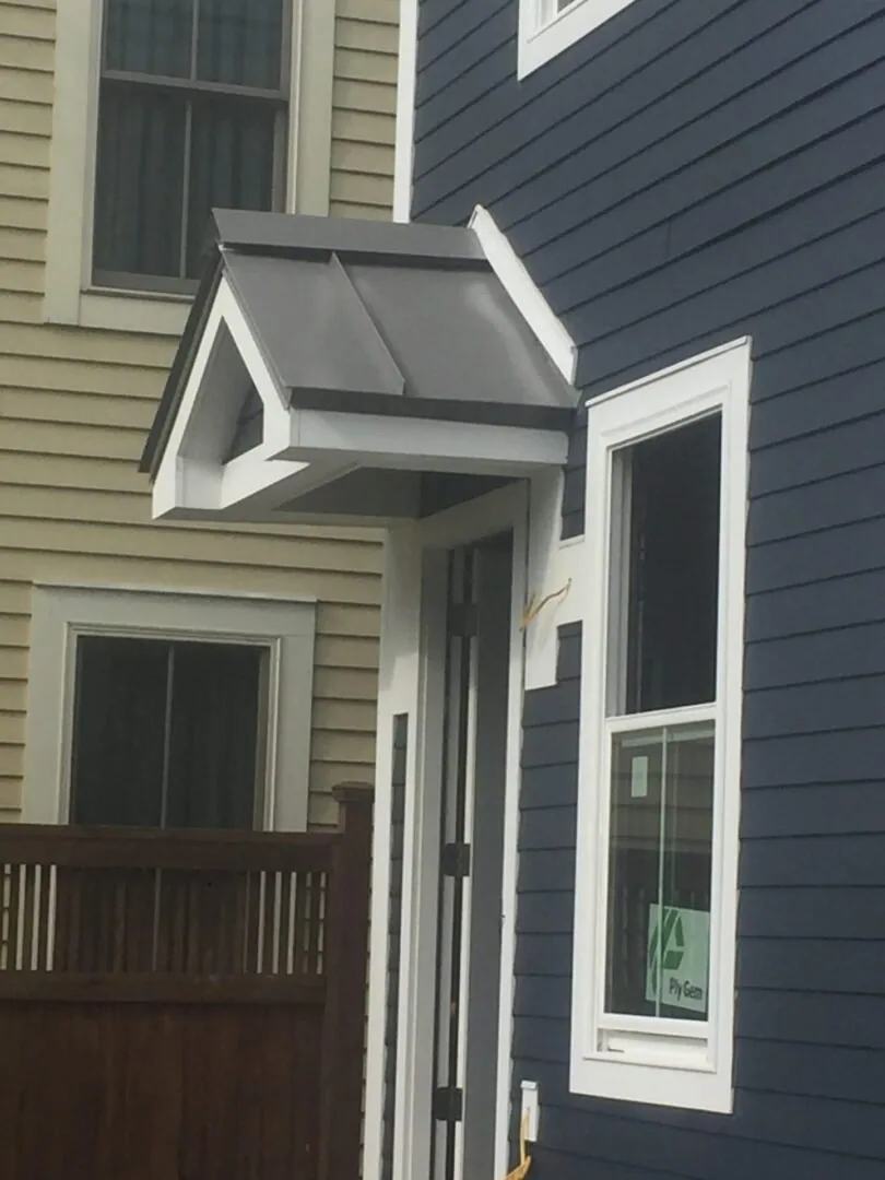 Metal roof panels running to the ridge on a residential property