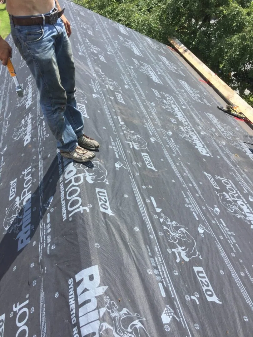 New roofing being installed over prepared decking