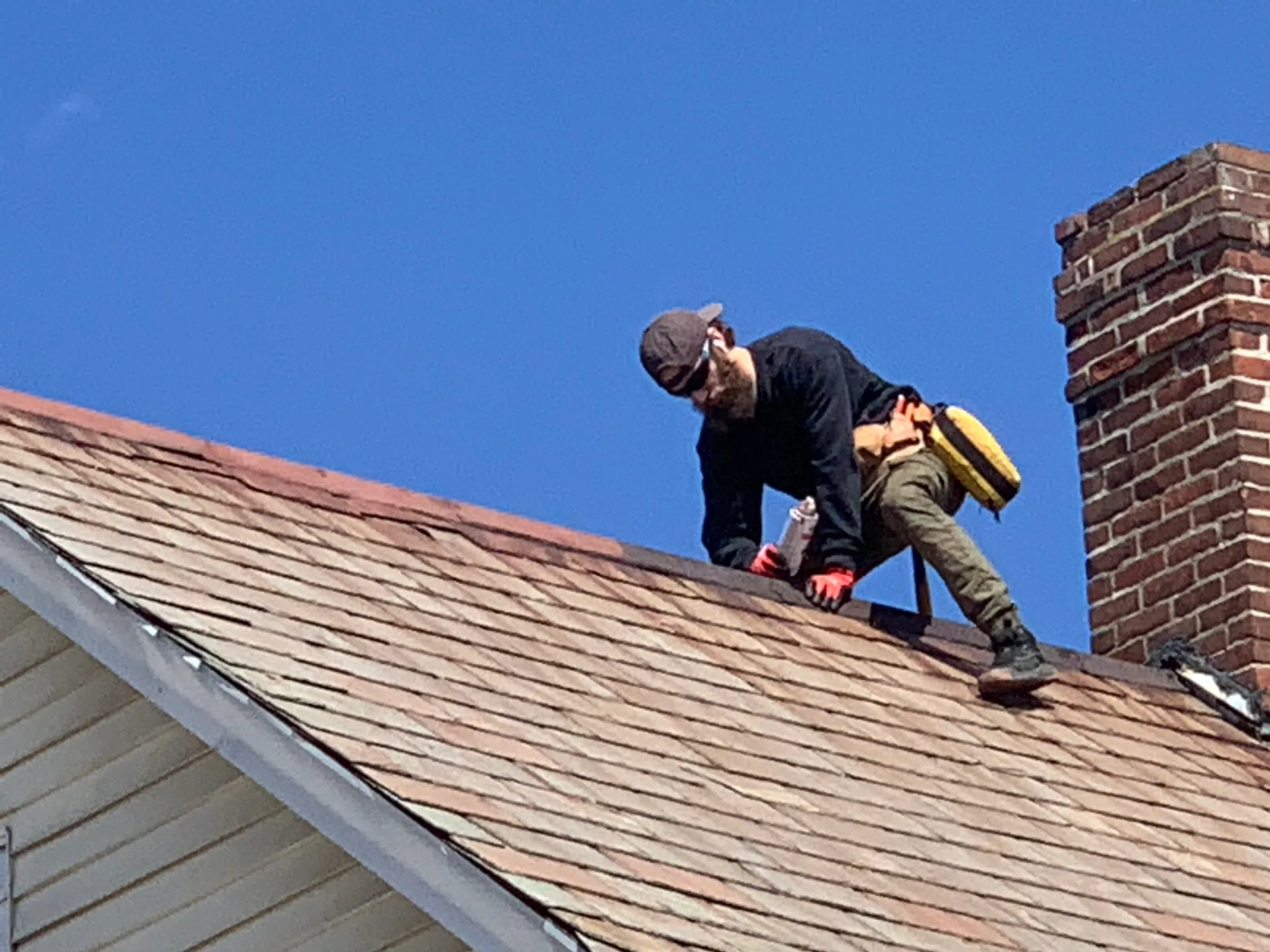 KC Builders roofer at work on a residential roof
