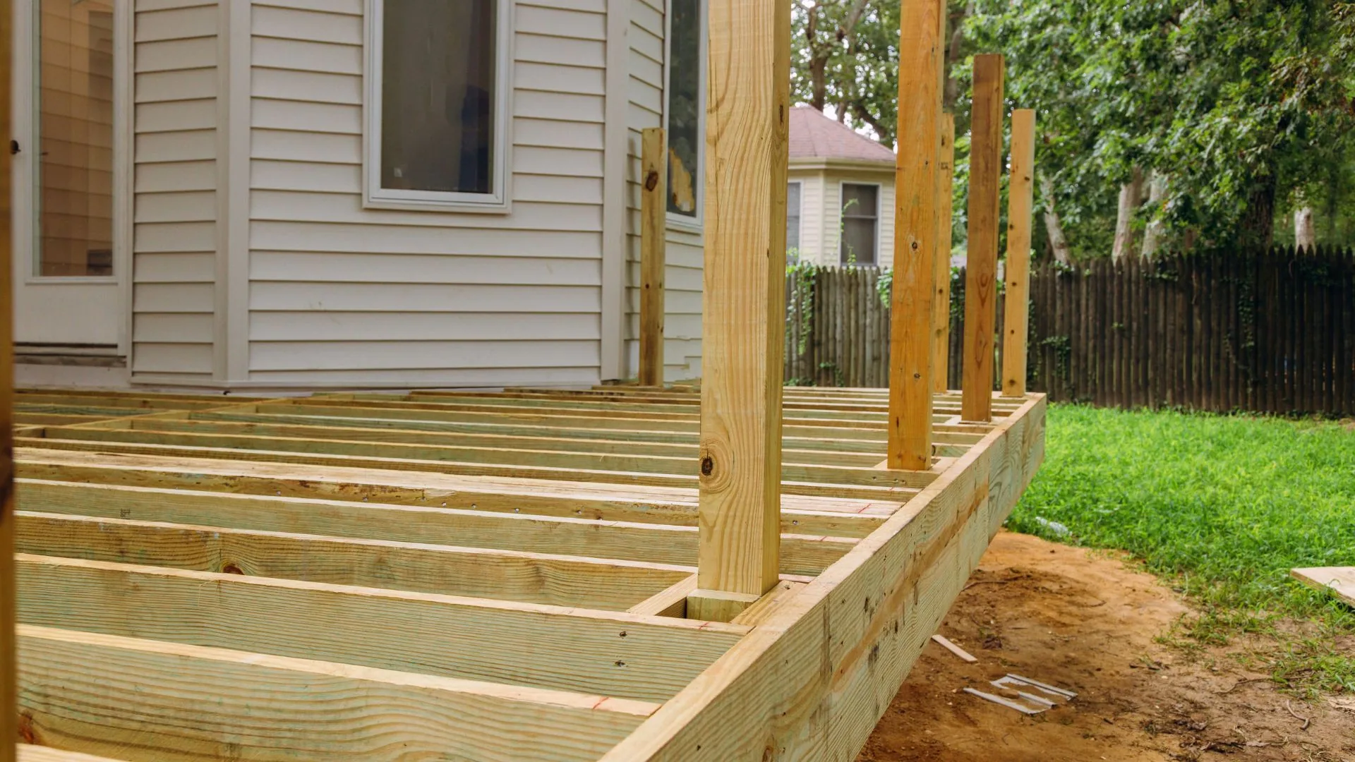 New deck under construction with joists and framing exposed