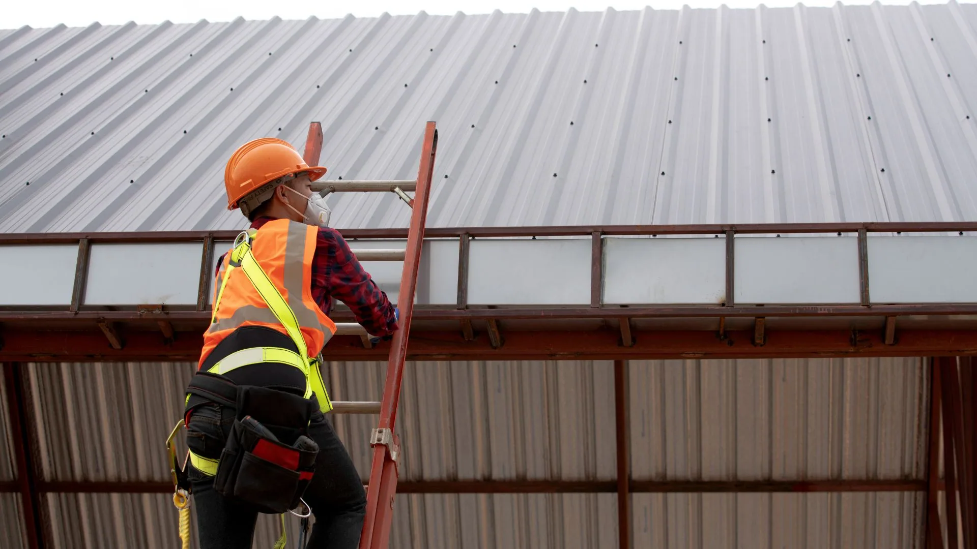 Metal roof panel being fitted with a fastener during installation