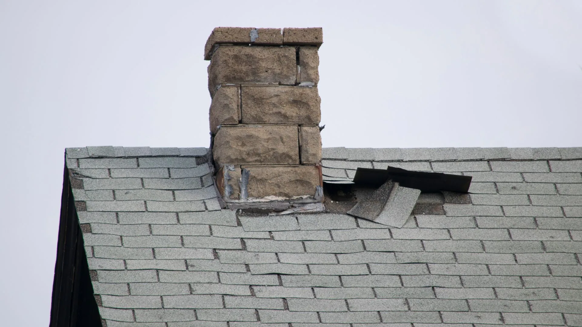 Metal flashing detail where a chimney meets the roof plane