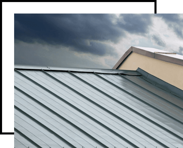 A metal roof with a cloudy sky in the background.